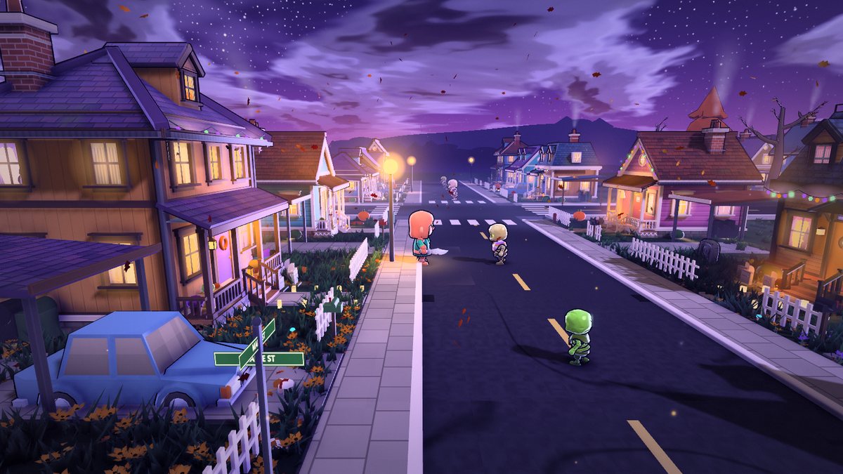 A residential street of lit houses with picket fences and luminaria.